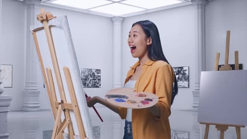 Female Looking At The Picture On Canvas Then Saying Wow While Painting In Gallery