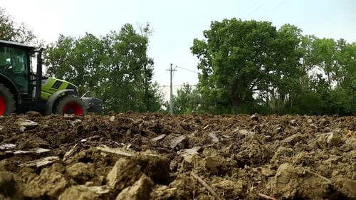 Tractor Plowing the Field on a Sunny Day