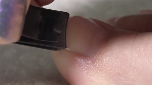 Close-Up of Toenail Being Trimmed with a Black Nail Clipper