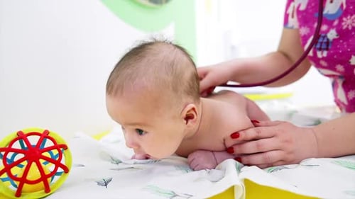 Baby Receiving Checkup with Stethoscope at Doctor's Office