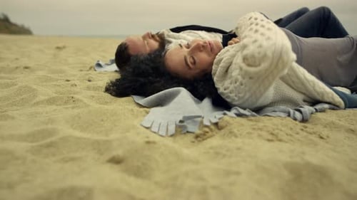 Romantic Couple Relaxing on Beach Shore
