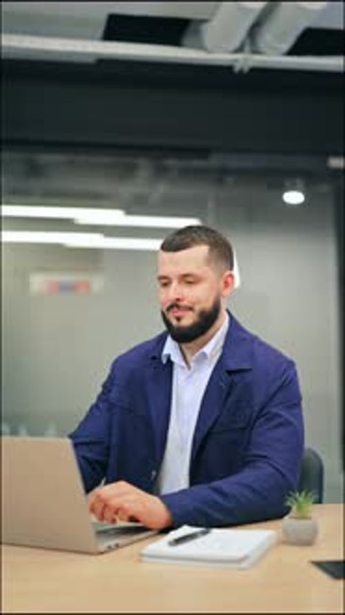Man Finishes Laptop Work and Leans Back Relaxed