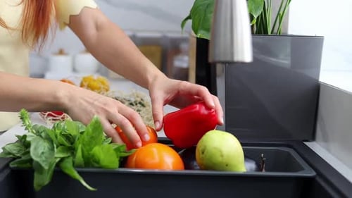 Woman Unloading Vegetables in Kitchen Interior