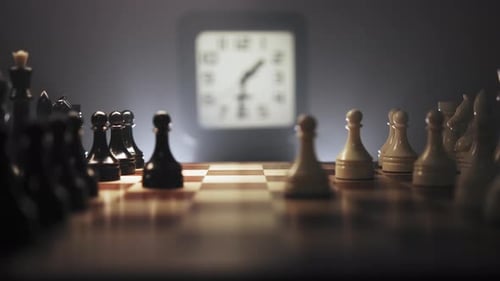 Movement Chess Pieces in Dark Environment with Clock in Background