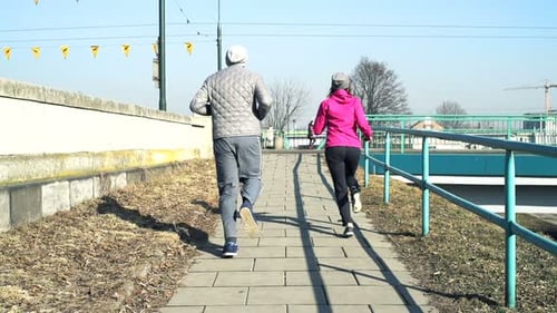 Sporty Couple Running In City Near Street, Super Slow Motion 240fps