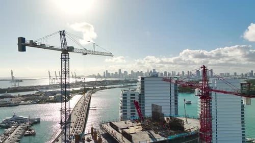 Tower Lifting Cranes at High Residential Apartment Building Construction Site Real Estate