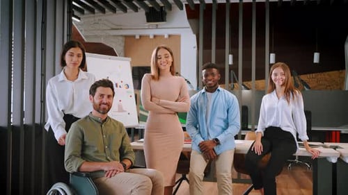 Office Workers of Different Races Smile Standing Together