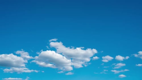 Fluffy Clouds Drifting in a Blue Sky