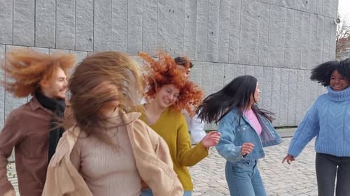 Urban Multiethnic Friends Dancing Happily in the Street