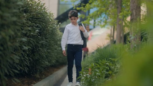 Schoolboy Walking Home Tired and Sad After a Long School Day