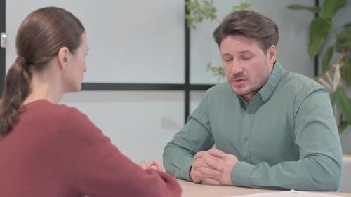 Man Having a Discussion With a Woman in Office