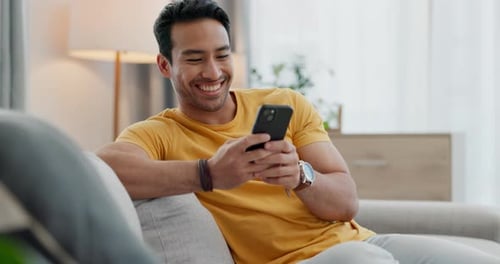 Home smartphone, smile and relax man typing, texting and reading app post