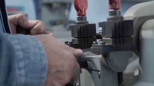 Close-up of Hispanic man working operating special for duplicating lock keys. Mexico.