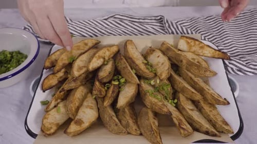 Freshly Baked Potato Wedges with Spices on a White Serving Tray