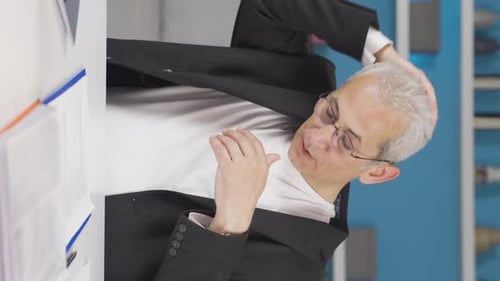 Vidéo verticale d'un employé de bureau à domicile qui suffoque à cause de la chaleur.