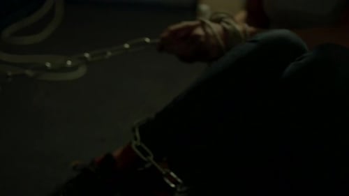 Tied up woman pulling on chains wrapped around her legs