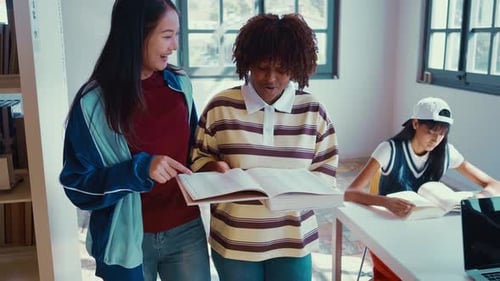 Students Study Together with Books in Library