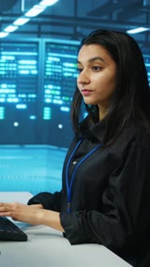 Woman Using Computer in a Modern Server Room