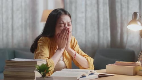 Tired Student Asleep at Desk with Books
