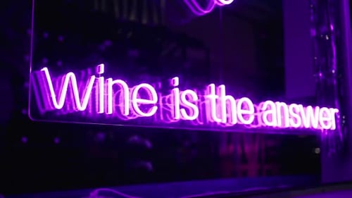 Vivid Imagery Capturing the Allure of a Wine Collection Neon Sign on Glass in the Night