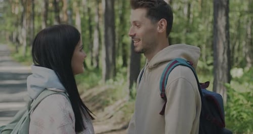 Slow Motion of Loving Couple Man and Woman Looking at Each Other Standing in Summer Forest Together
