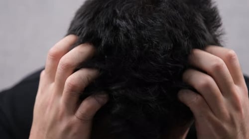 Close Up of Man Scratching His Head