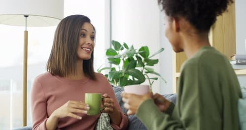 Two Friends Chatting on Sofa with Coffee
