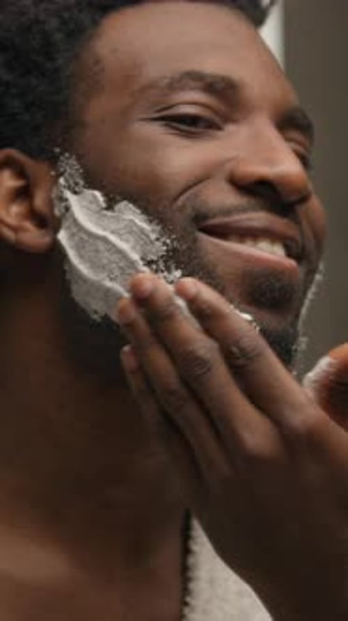 Man Applies Shaving Cream to His Face