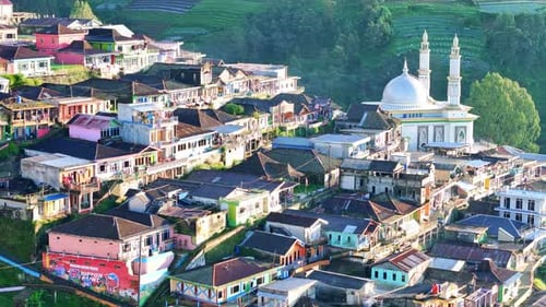 Aerial view of a picturesque Indonesian highland village with colorful houses, a mosque