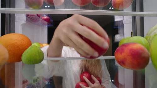View From Inside the Fridge Woman Opens Side By Side Fridge Doors Puts Tomatos Then Closes It Female