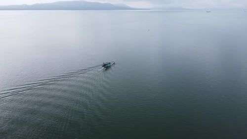 A fishing boat sailing out to sea to catch fish
