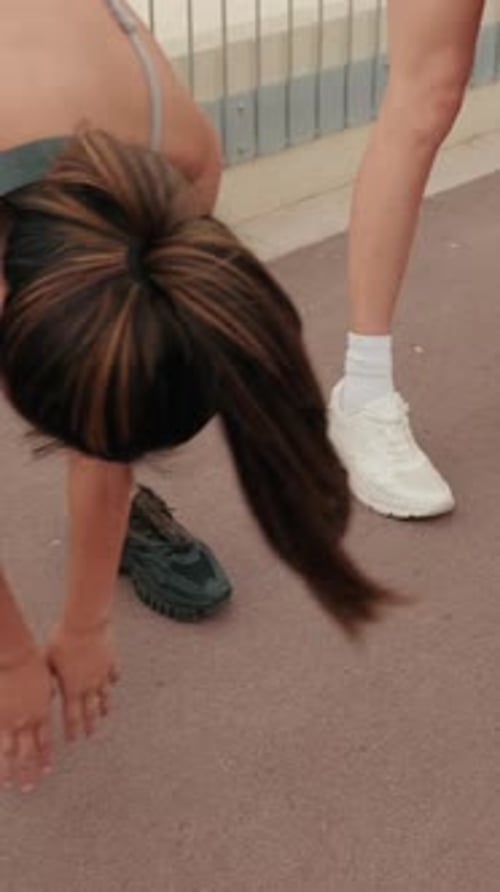 Vertical video, Women Stretching Before Beach Workout