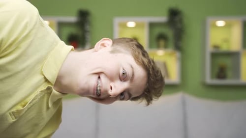 Close-up portrait of cheerful young man looking at camera.