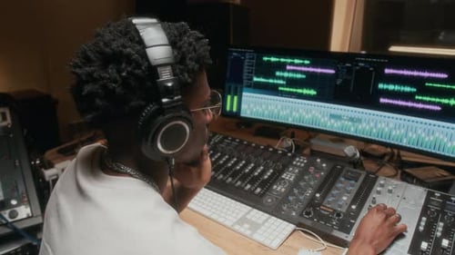 Sound Engineer Mixing Music in Recording Studio