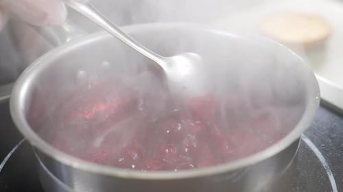 Cooking Cherry Berry Sauce in Pan Slow Motion Cooking in Luxury Restaurant Vibrant Bubbling Crimson