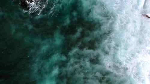 Top Down Video of Waves Crashing in Ocean Near Uluwatu Temple in Bali Indonesia
