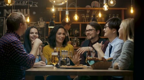 Diverse Group of Young People Have Fun in Bar, Talking, Telling Stories and Jokes. They Drink Vario