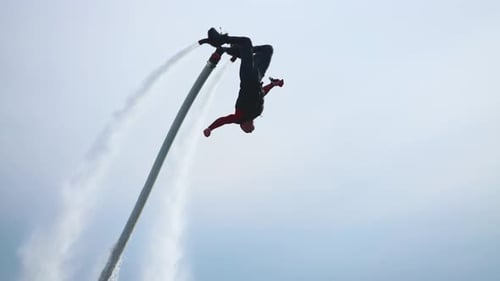Flyboard a New Extreme Sport A Man a Flyboarder Performs Flips Over the Water An Agile and Trained