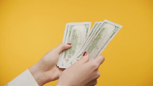 Unrecognizable Hands Counting Cash Money on Yellow
