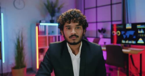 Professional Man Smiles in Modern, Techy Office