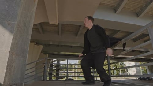 Young Adult Performing Parkour Jumps in Urban Area