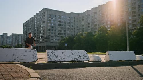 Athletic Man Performing Parkour Move in Urban Setting