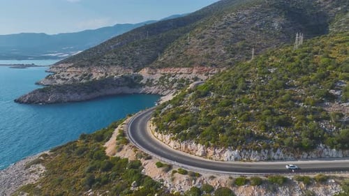 Aerial View Couple on a Road Trip Along the Azure Mediterranean in a Convertible