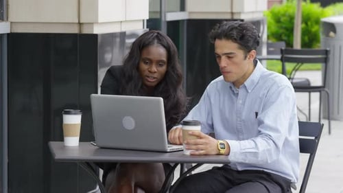 Business Colleagues Working Together at Outdoor Cafe Table
