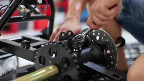 Workers are Making a Motorcycle in the Workshop Preparing the ATV for Sale
