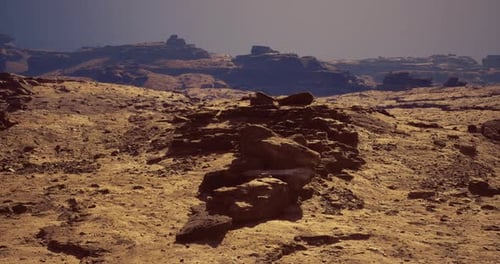 Expansive Desert Landscape with Rocky Formations Under Clear Skies