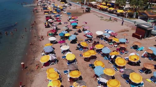 drone view of colorful parasol on the beach