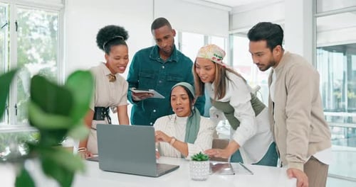 Team Collaborating on Laptop in Modern Office
