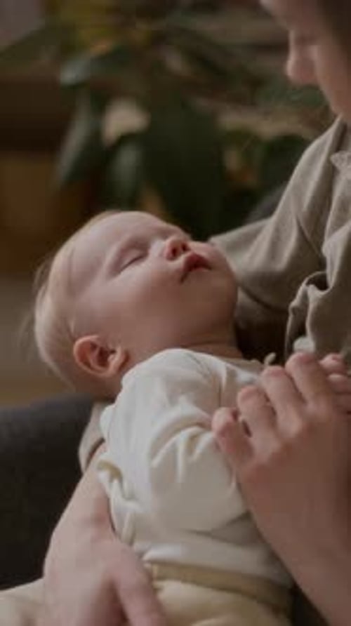 Fair-Haired Infant Being Held by Adult