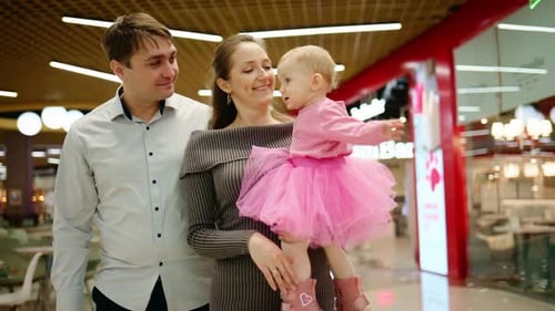 A Family Enjoys a Day Out Capturing Joyful Moments Together in a Vibrant Shopping Mall with Love and